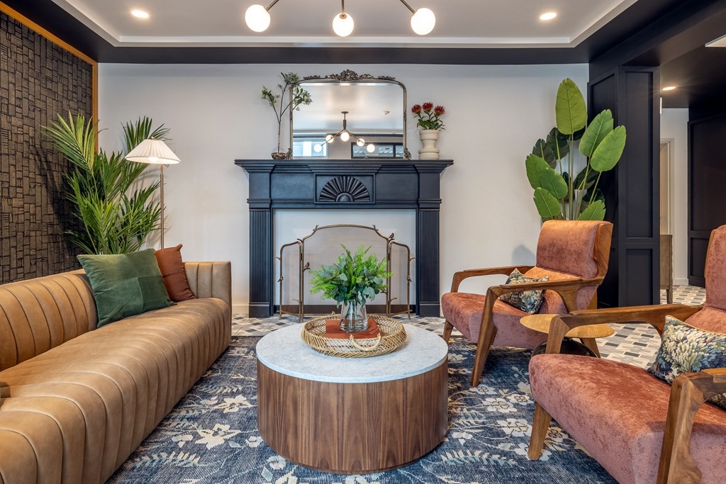 a living room with couches and chairs and a fireplace