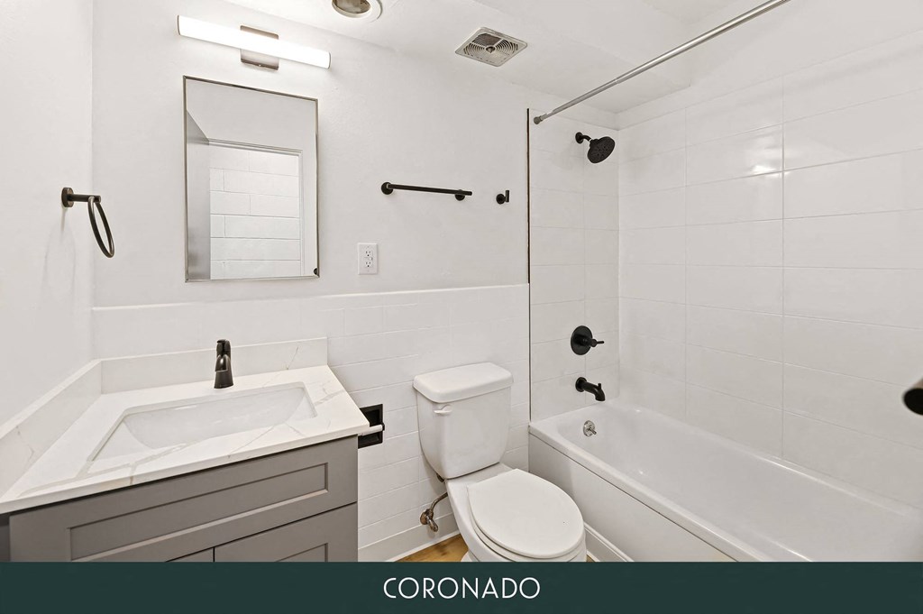 a white bathroom with a sink toilet and tub