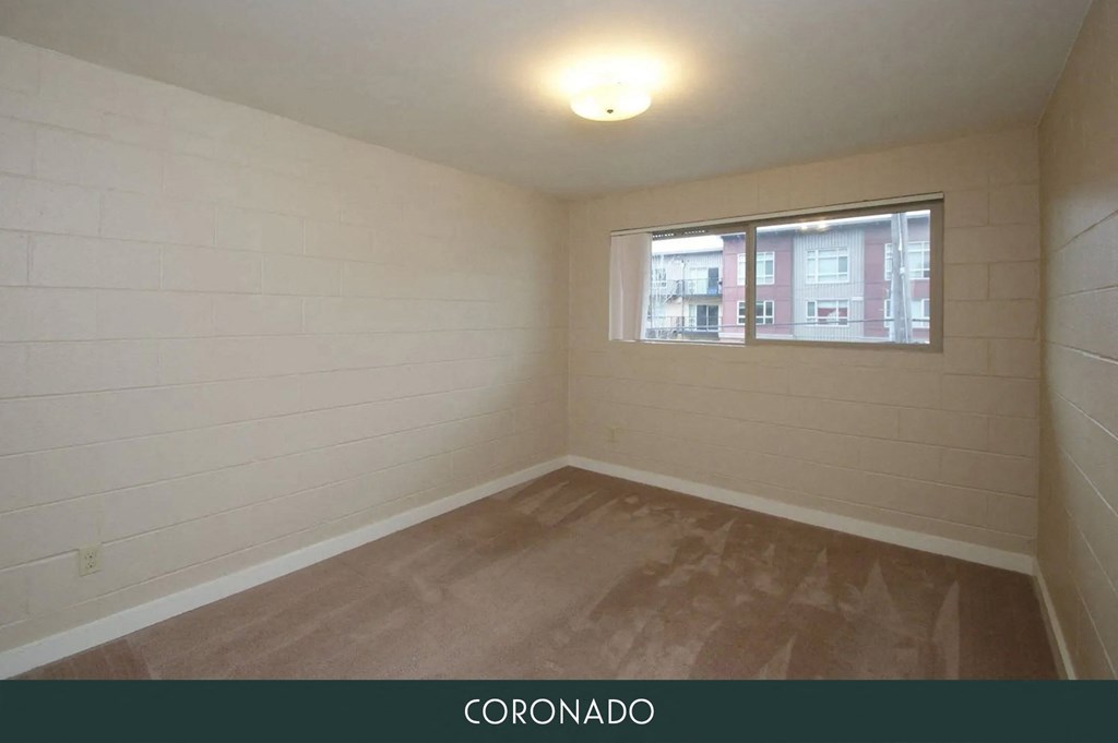 the living room of an empty room with a window