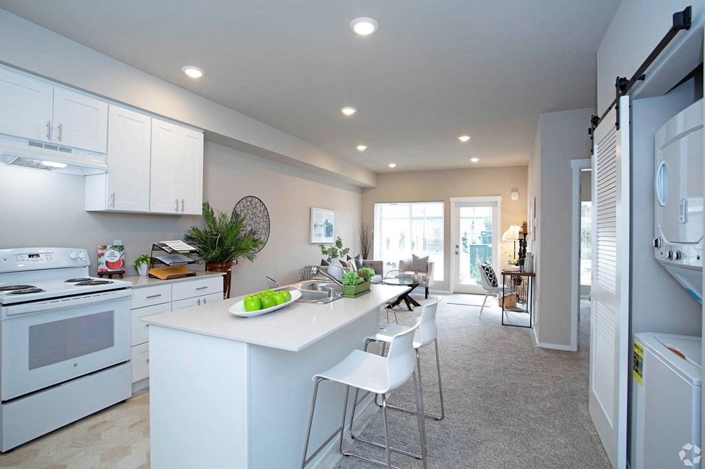 a white kitchen with white cabinets and white appliances