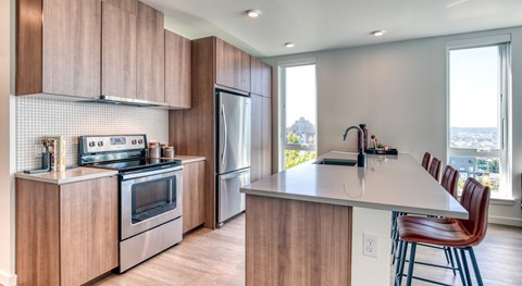 A kitchen with wooden cabinets and a white island.