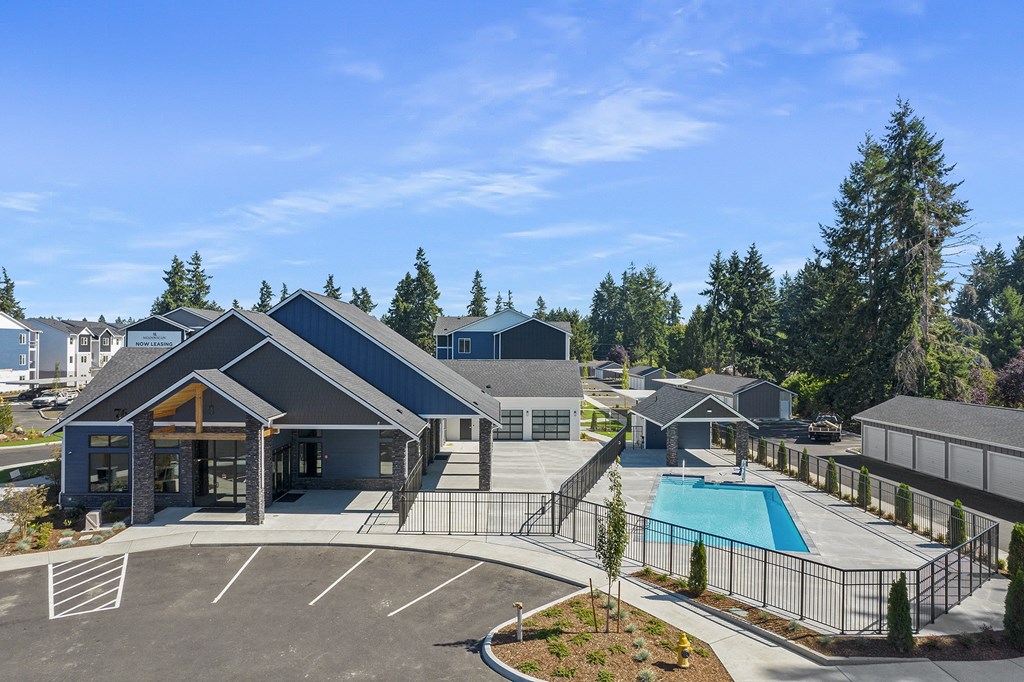 A large building with a pool in front of it.