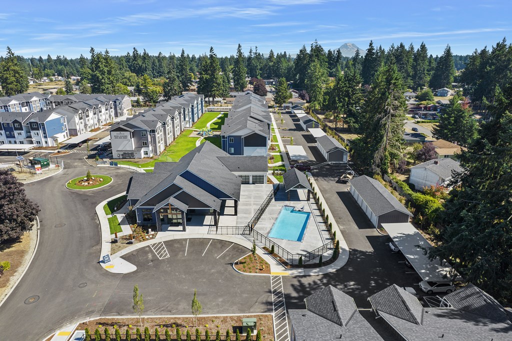 A large building complex with a swimming pool in the middle.