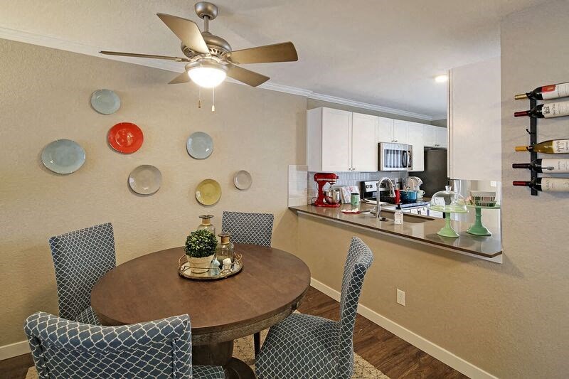 a kitchen and dining room with a table and chairs