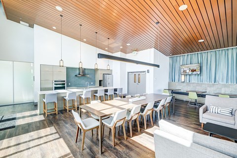 A modern dining room with a wooden table and chairs.