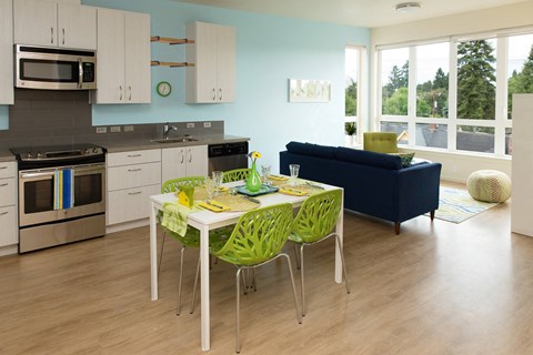 a kitchen and dining room with a table and chairs