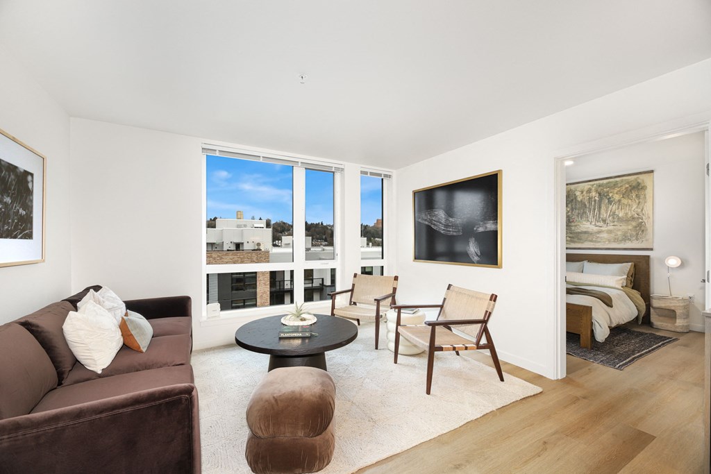 A living room with a brown couch and a coffee table.