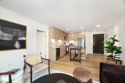 A living room with a brown chair and a brown ottoman.
