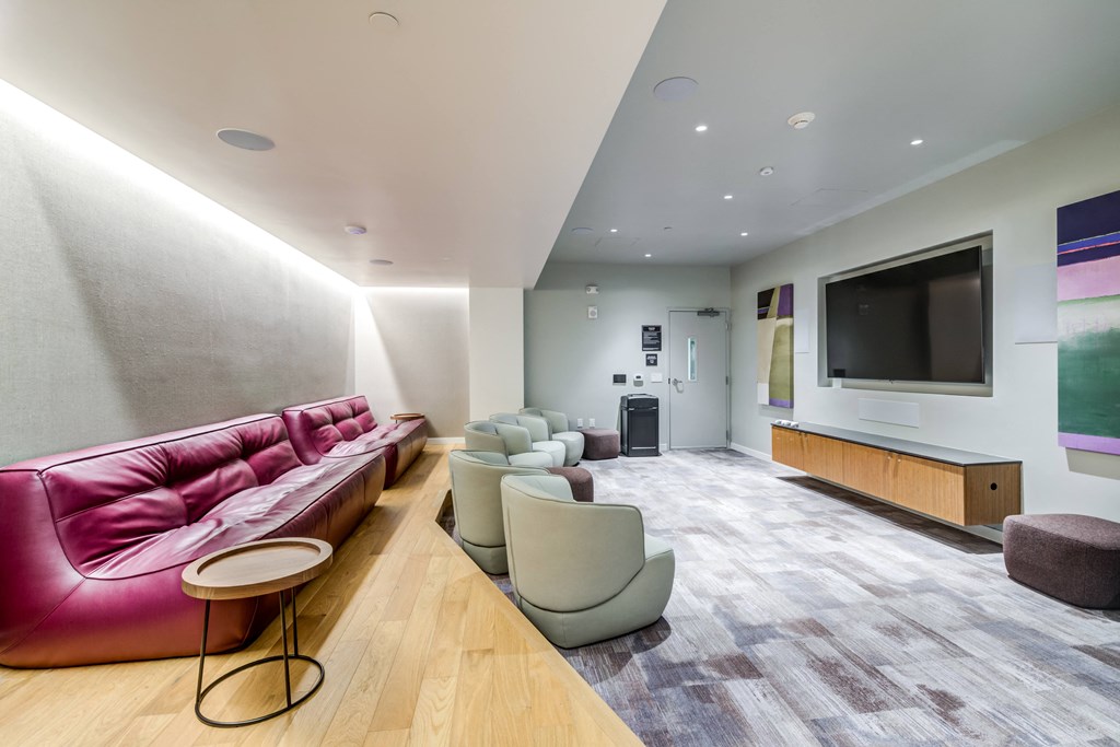 a living room with couches and chairs and a television