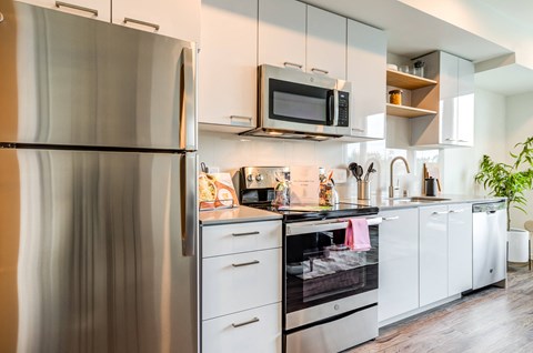 a kitchen with stainless steel appliances and white cabinets