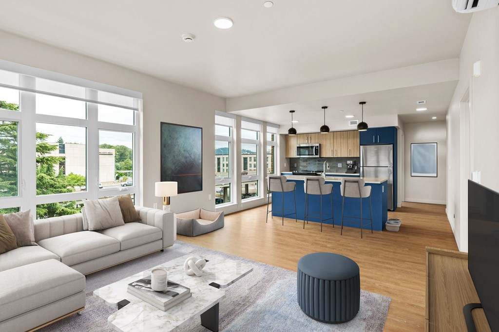 A modern living room with a white sofa and a blue coffee table.