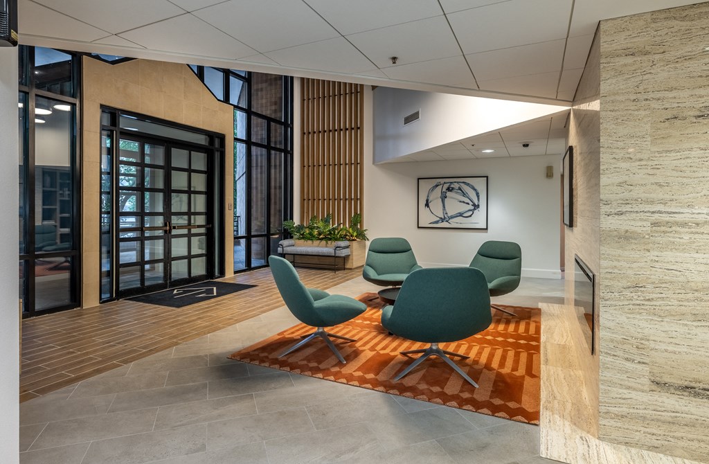 a conference room with a table and chairs on a rug