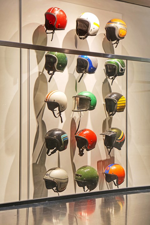 A wall of helmets in various colors.