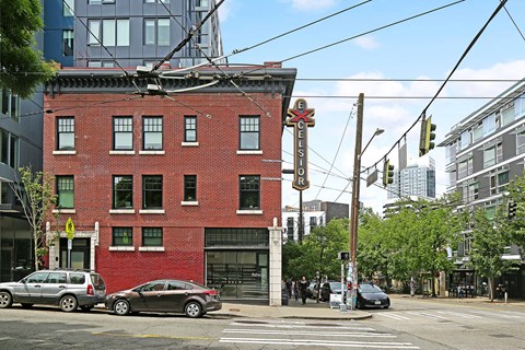 A red brick building with a sign that says "EXCELSIOR" on it.