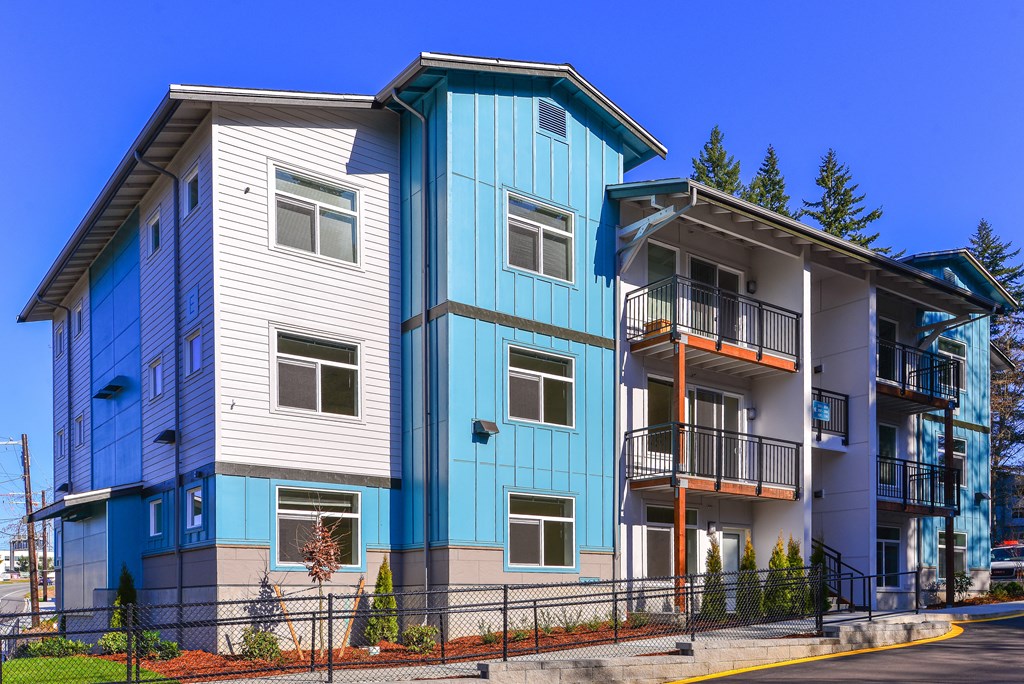 a row of blue and white apartment buildings next to each other
