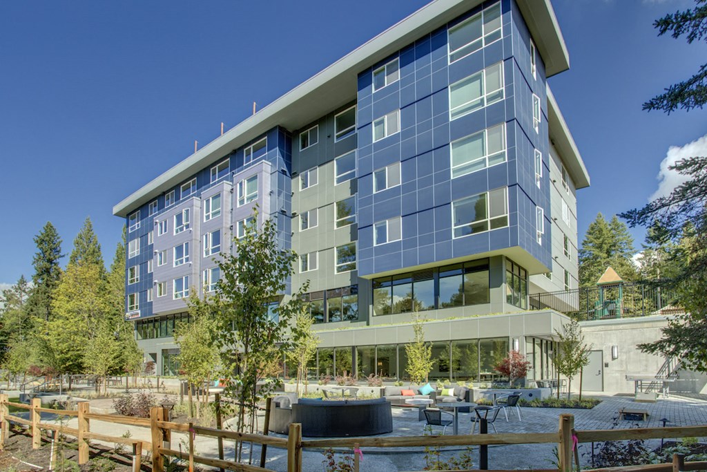 an office building with a fountain in front of it