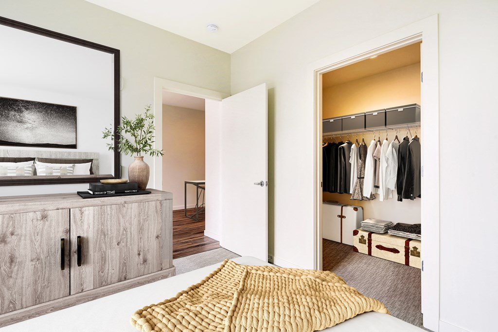 a bedroom with a bed and a closet with a mirror