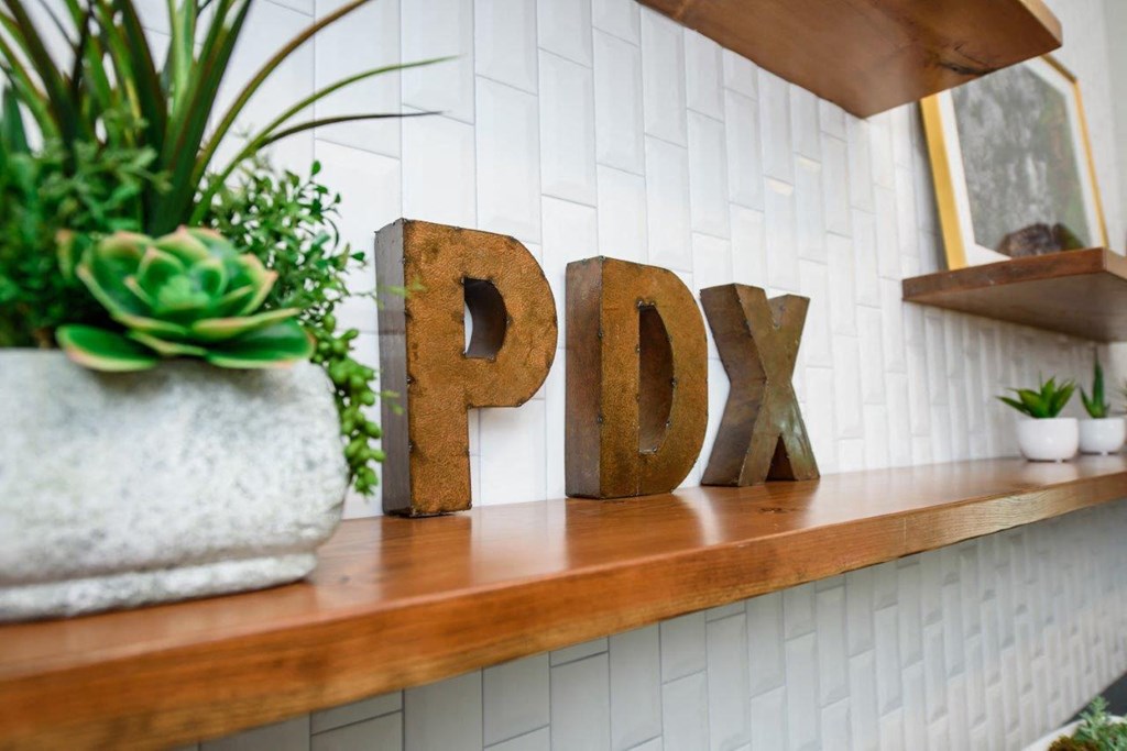 a wooden sign that says pdq on a shelf