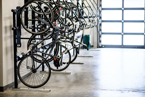 a row of bikes parked in a bike rack