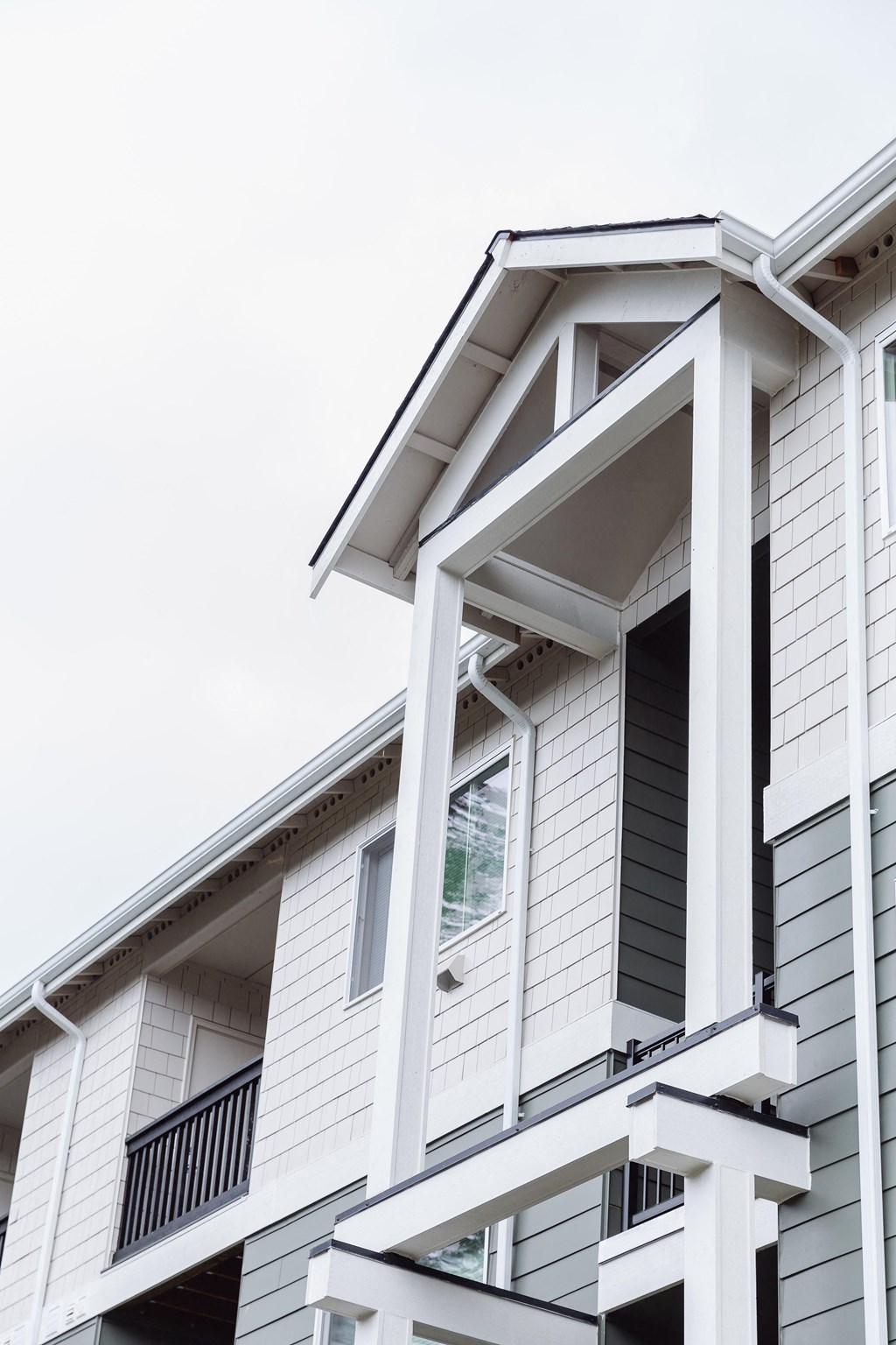 a white house with white siding and a window
