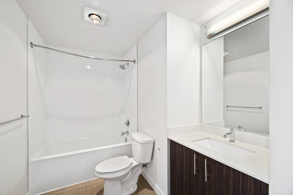 a bathroom with a shower toilet and sink