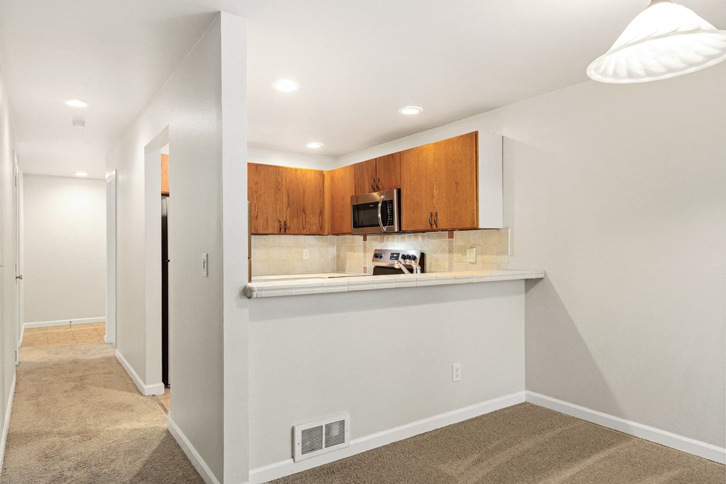 a kitchen with a counter and a microwave in a house
