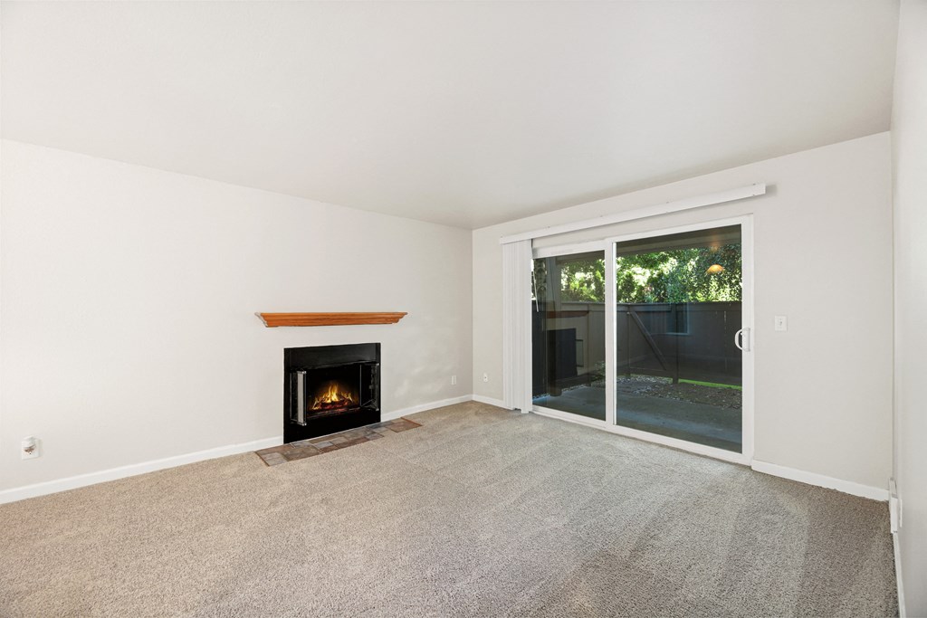a living room with a fireplace and a sliding glass door