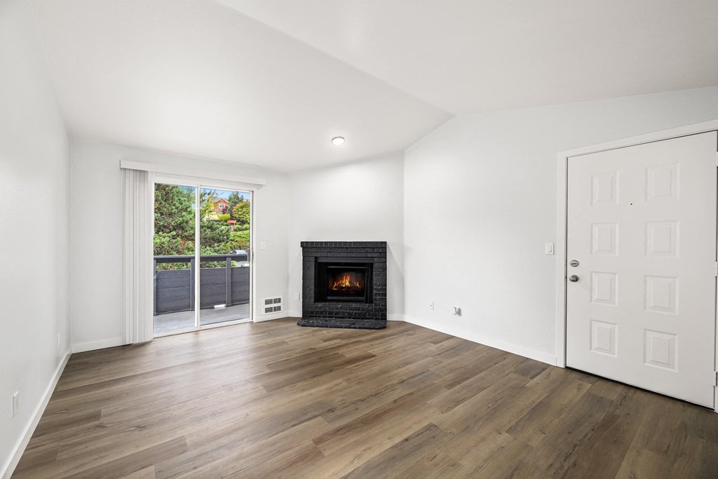 a living room with a fireplace and a door to a patio