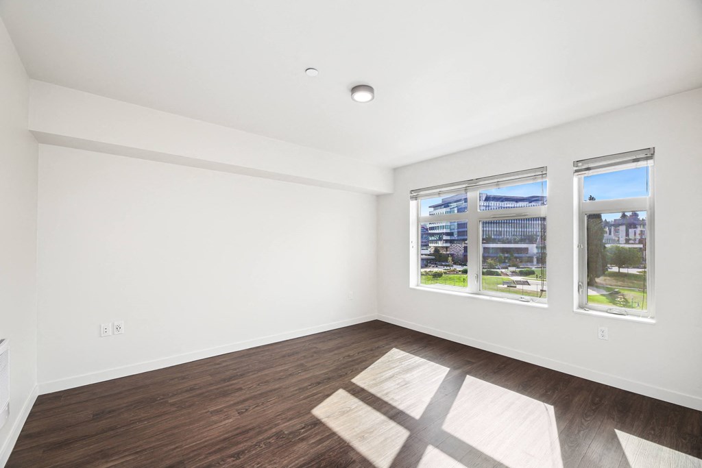 a living room with white walls and wood floors