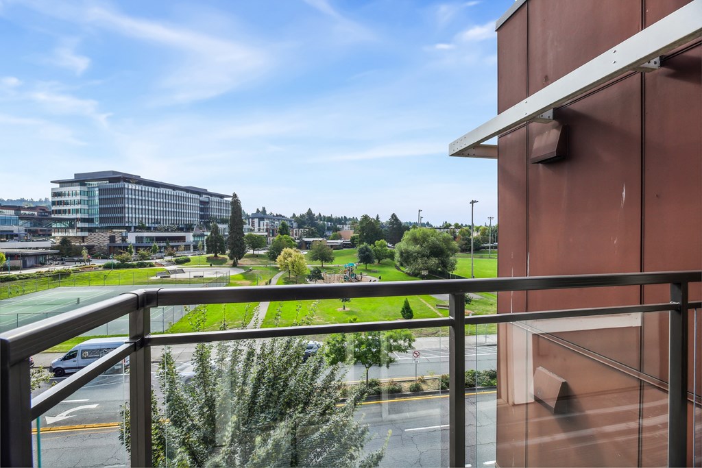 a balcony with a view of a park and some buildings