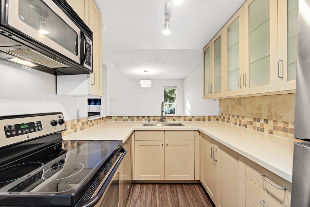 an empty kitchen with a stove and a sink
