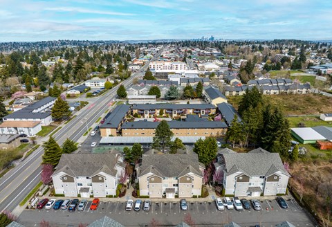 A view of a residential area with houses and a parking lot.