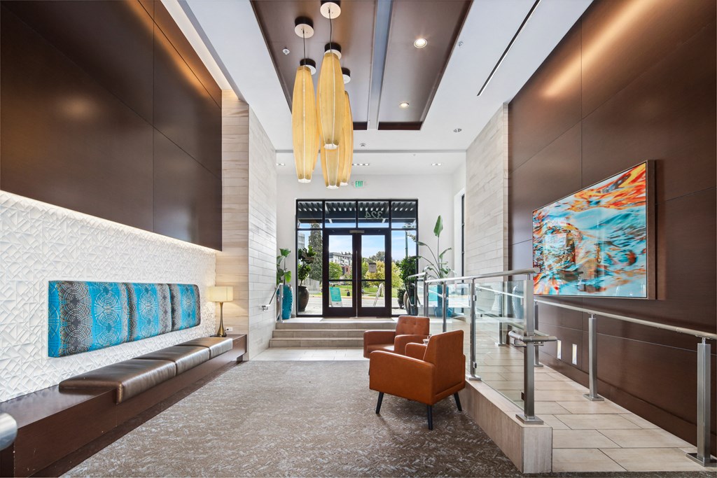 a lobby with a seating area and a glass door