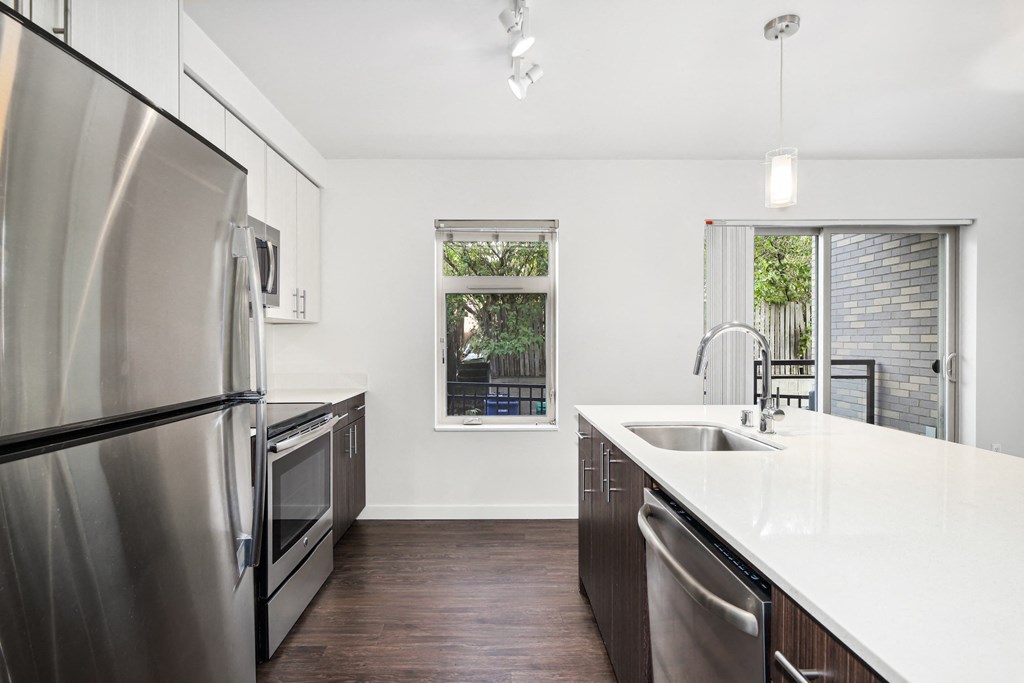 a kitchen with stainless steel appliances and a large counter top