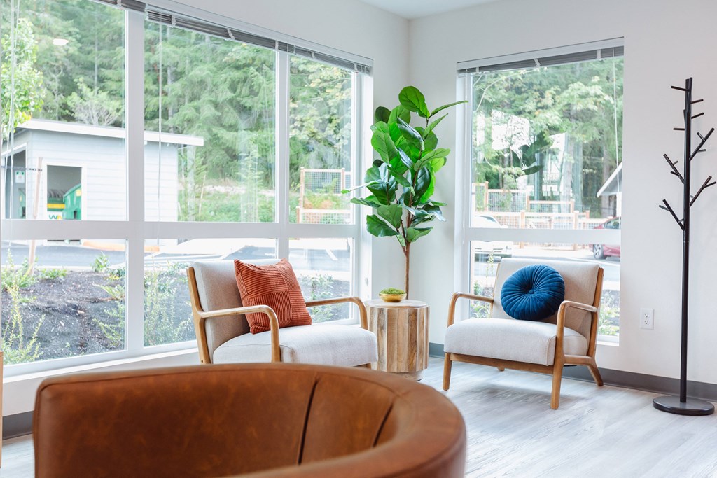 a living room with two chairs and a large window