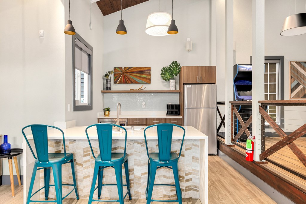 a kitchen with blue chairs and a marble counter top