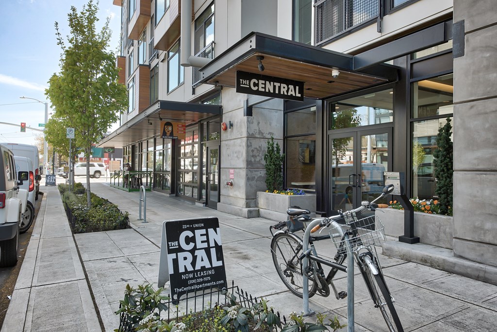 A bicycle is parked in front of a sign that says "The Central".