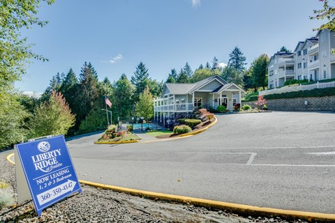 a home for sale sign on the side of a road