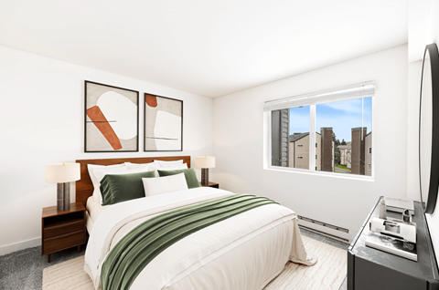 A bedroom with a large bed and a television.