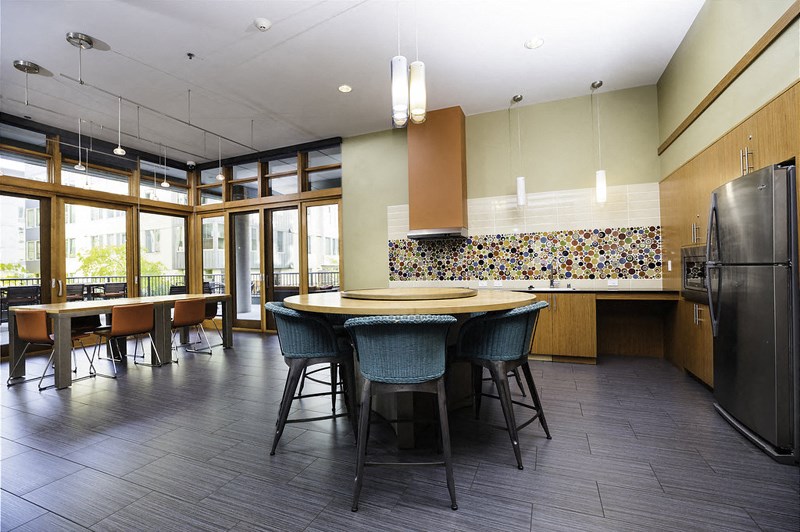 a kitchen with a large table and chairs and a refrigerator