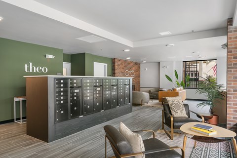 A modern office space with a green wall and a wooden reception desk.