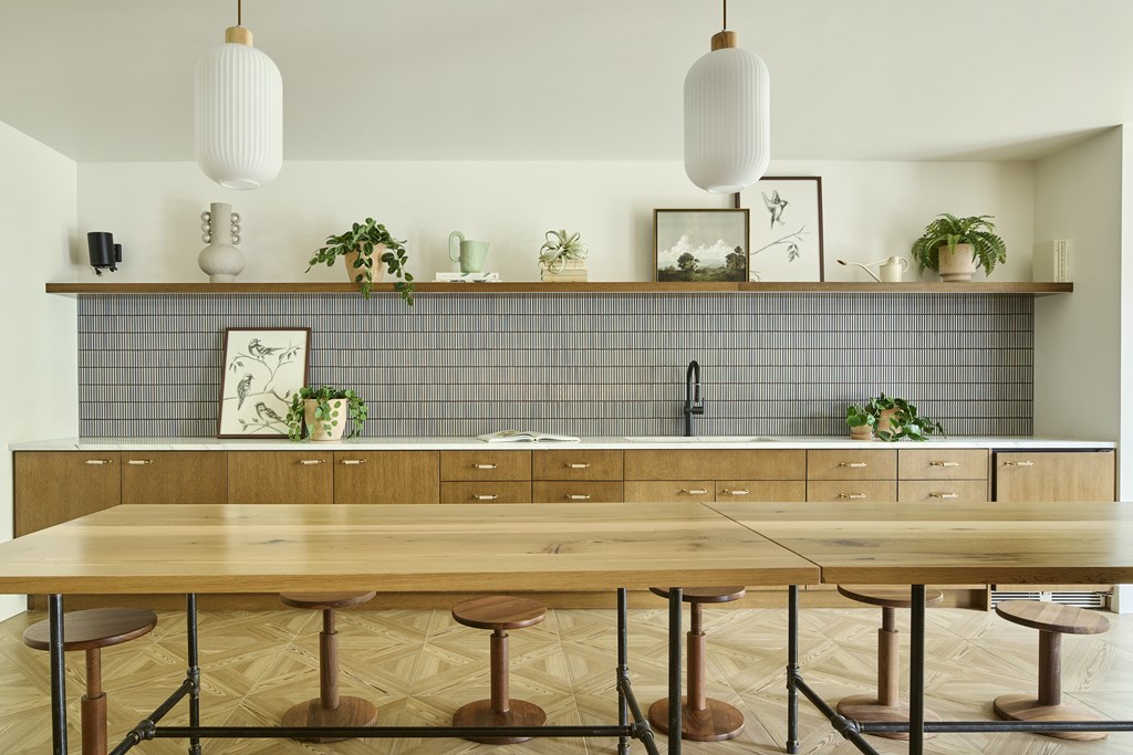 A kitchen with a wooden table and stools.