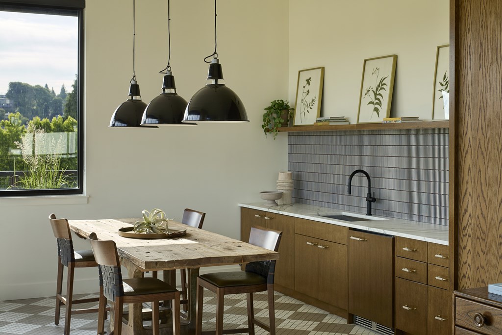 A kitchen with a table and chairs and a window.