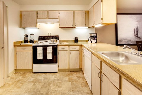 a large kitchen with white cabinets and a sink