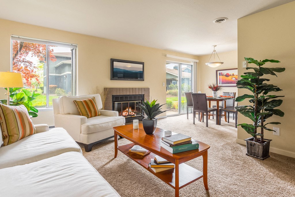 a living room with a couch and a coffee table and a fireplace