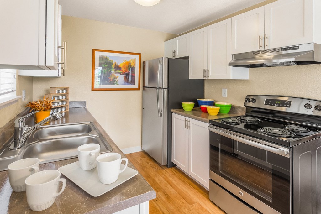 a kitchen with stainless steel appliances and white cabinets