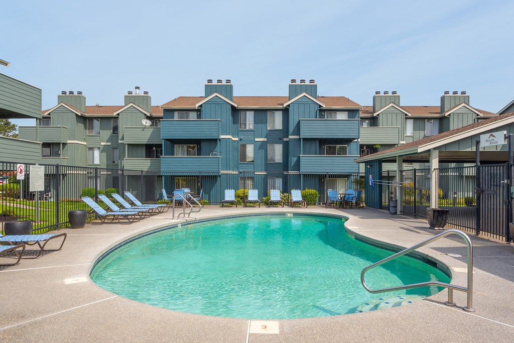 a resort style pool with a building in the background