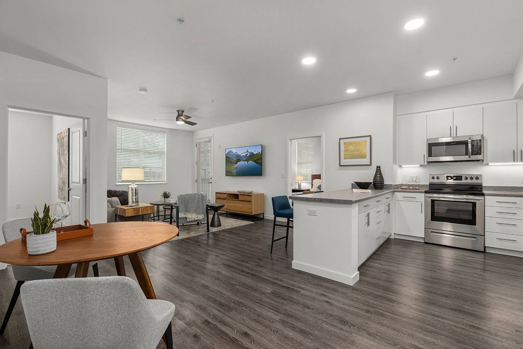 A modern kitchen with a dining table and chairs.