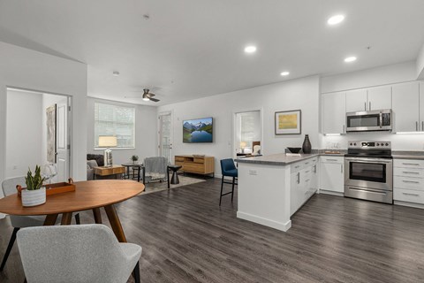 A modern kitchen with a dining table and chairs.