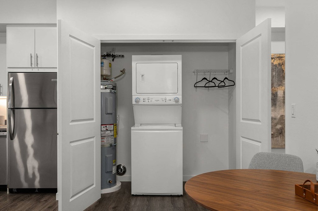 A small kitchen with a refrigerator, a microwave, and a dishwasher.